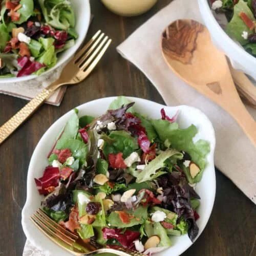 Colorful garden salad with mixed greens, feta cheese, and sliced almonds. Perfect for healthy dining.